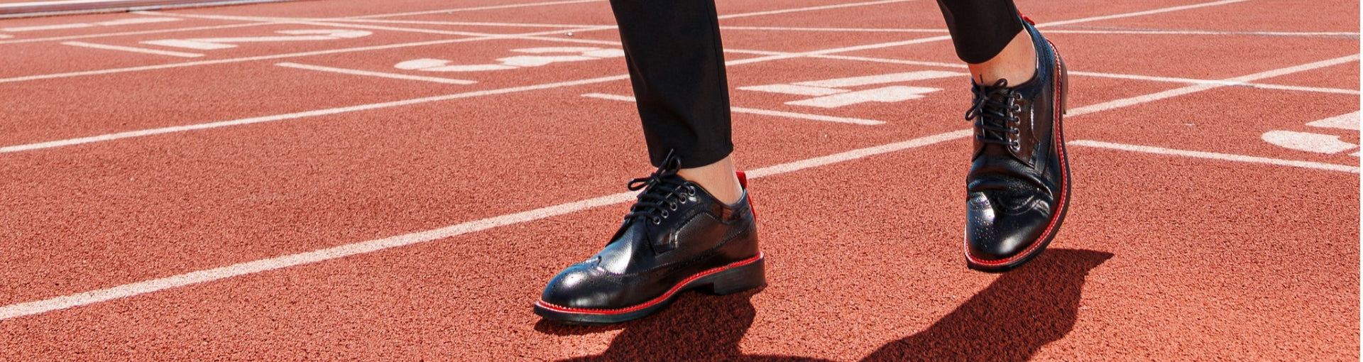 Men wearing Pintta Dublin Black luxury shoes walking on a running track, showcasing quiet confidence and European craftsmanship