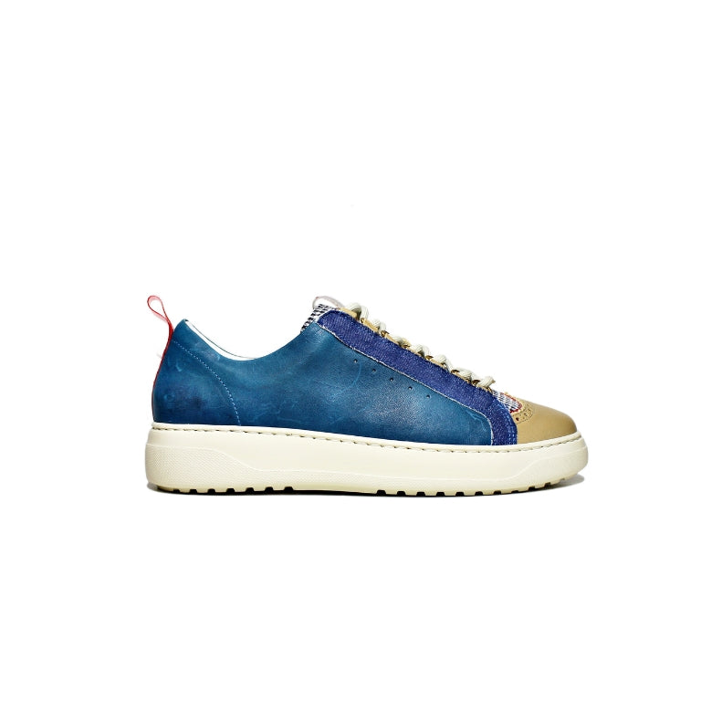 Blue vegetable-tanned leather sneakers with checkered fabric details, giving them a unique look.